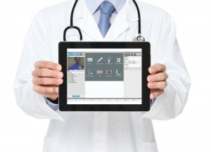 Doctor holding an ipad implementing telehealth strategies. 