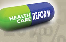A pill with white letters saying Health Care Reform. One side is green and the other blue. What the ACA will cost you