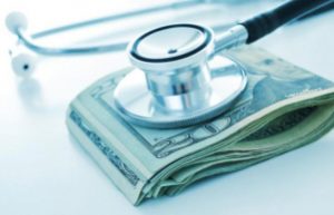 A stock ofUS dollar currency below the head of a black stethoscope. Government health plans and private healthcare plan options are becoming more expensive. 