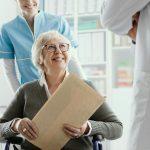 Senior patient on wheelchair with medical staff