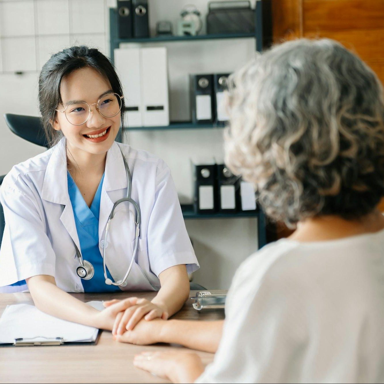 The doctor holds the patient’s. hand Healthcare and medical concept.