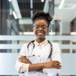 Confident female doctor standing with stethoscope in modern hospital