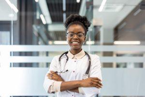 Confident female doctor standing with stethoscope in modern hospital