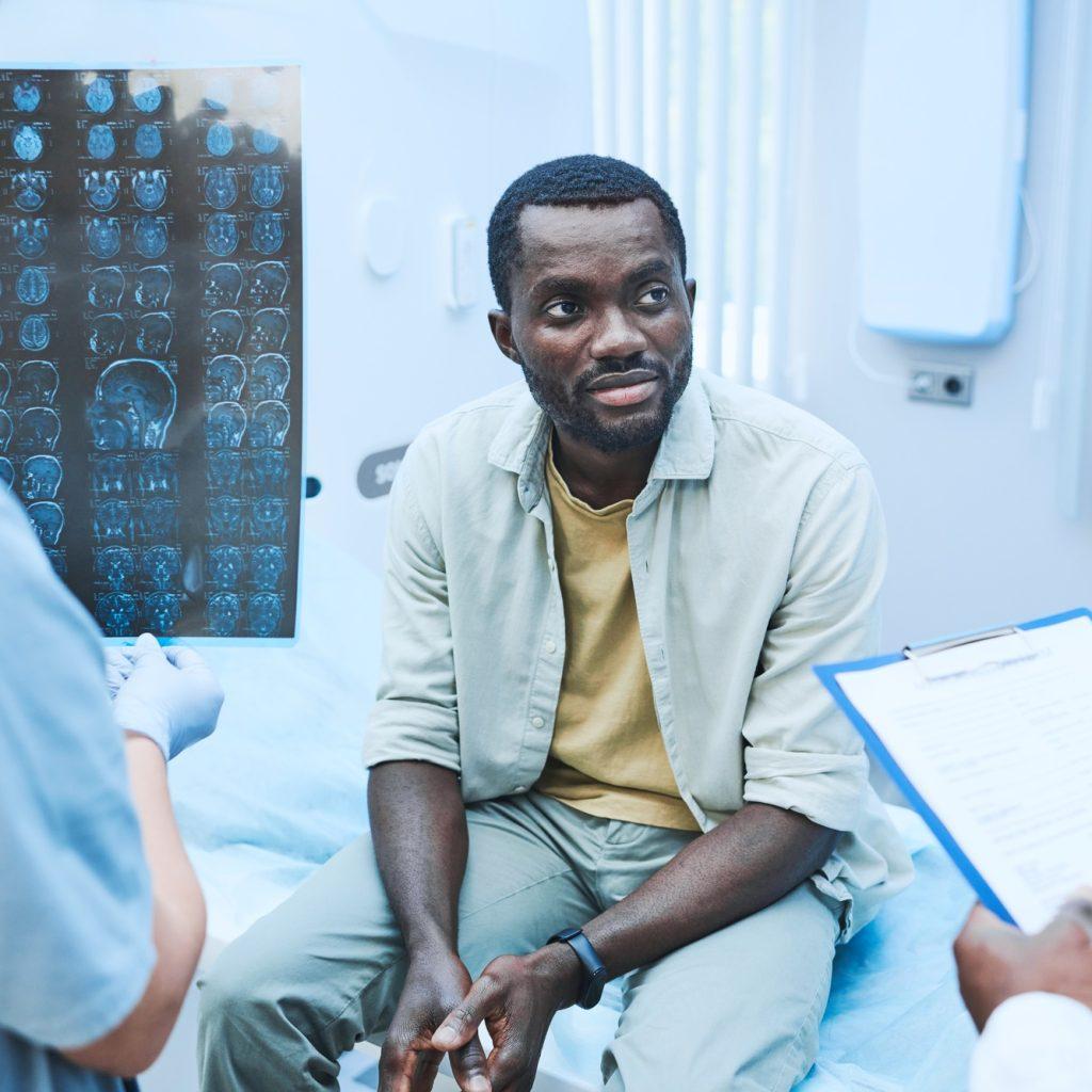 Black patient lisening to doctors