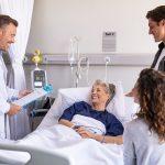 Doctor visiting senior patient with family