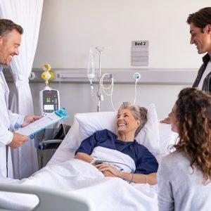 Doctor visiting senior patient with family